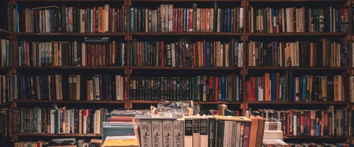 A tranquil library filled with books on wooden shelves, offering a warm, inviting atmosphere.